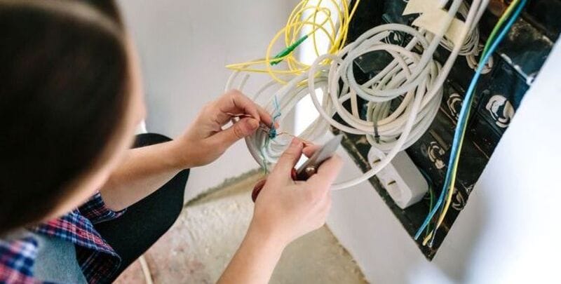 A technician installing data cabling